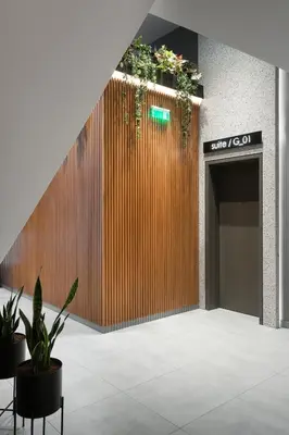 a lobby with a wooden wall with plants on it at 11 Enteka Acropolis Suites in Athens