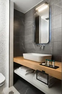 a bathroom with a sink and a mirror at 11 Enteka Acropolis Suites in Athens