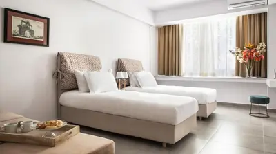 a hotel room with a bed and a couch at The Square Six in Athens