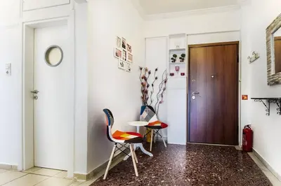 a hallway with two chairs and a table at Gazi apartment with Acropolis views in Athens