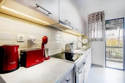 a kitchen with a red appliance on a counter at Gazi apartment with Acropolis views in Athens