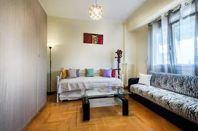 a living room with a bed and a couch at Gazi apartment with Acropolis views in Athens