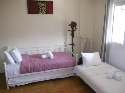 a bedroom with a pink bed and two white pillows at Gazi apartment with Acropolis views in Athens