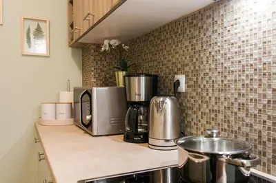a kitchen counter with a coffeemaker and a coffee maker at A Modern Antique Central 3 Bedroom Simple Apartment near to Acropolis in Athens
