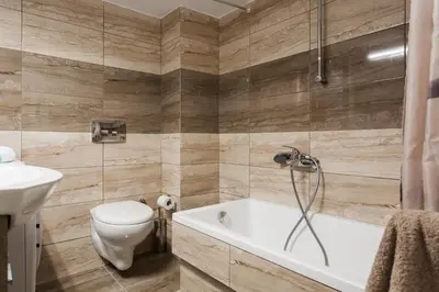a bathroom with a tub and a toilet and a sink at A Modern Antique Central 3 Bedroom Simple Apartment near to Acropolis in Athens