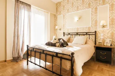 a bedroom with a bed with a stuffed animal on it at A Modern Antique Central 3 Bedroom Simple Apartment near to Acropolis in Athens