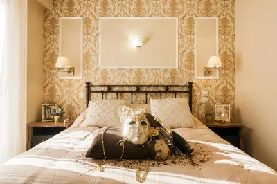 a woman laying on a bed with a mask at A Modern Antique Central 3 Bedroom Simple Apartment near to Acropolis in Athens