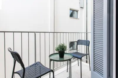 two chairs and a table on a balcony at A Modern Antique Central 3 Bedroom Simple Apartment near to Acropolis in Athens