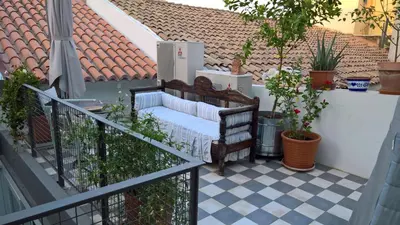 a balcony with a bench on a tile floor at Under the Acropolis, tiny room, big terrace in Athens