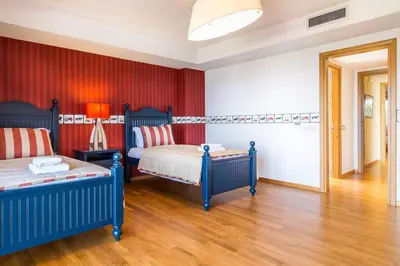a bedroom with two beds and red walls at Amazing 5 bedroom Villa with Swimming Pool in Athens