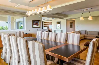 a dining room and living room with a table and chairs at Amazing 5 bedroom Villa with Swimming Pool in Athens