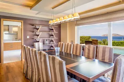 a dining room with a table and chairs with a view at Amazing 5 bedroom Villa with Swimming Pool in Athens