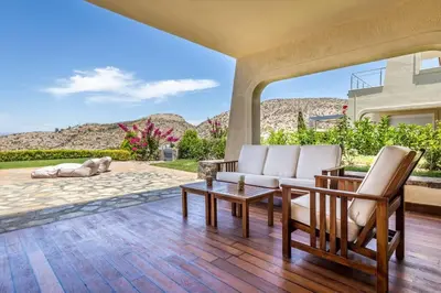 a living room with two chairs and a table at Amazing 5 bedroom Villa with Swimming Pool in Athens