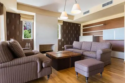 a living room with two couches and a coffee table at Amazing 5 bedroom Villa with Swimming Pool in Athens