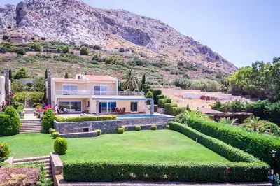 a house with a mountain in the background at Amazing 5 bedroom Villa with Swimming Pool in Athens