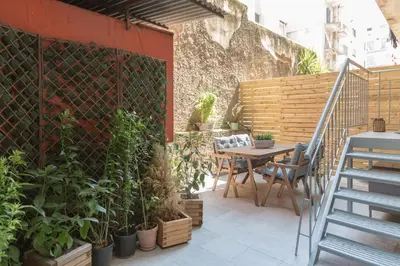 a patio with a table and chairs and plants at Cozy Flat with Terrace & Patio, next to Lycabettus in Athens