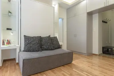 a living room with a couch with pillows on it at Cozy Flat with Terrace & Patio, next to Lycabettus in Athens