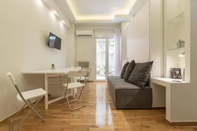 a living room with a couch and a table at Cozy Flat with Terrace & Patio, next to Lycabettus in Athens