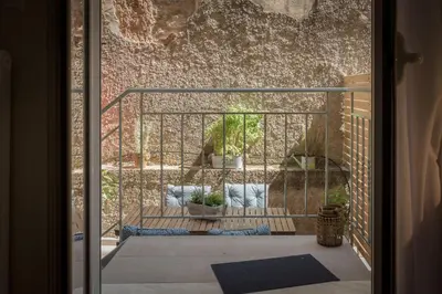 a view from the door of a balcony with potted plants at Cozy Flat with Terrace & Patio, next to Lycabettus in Athens