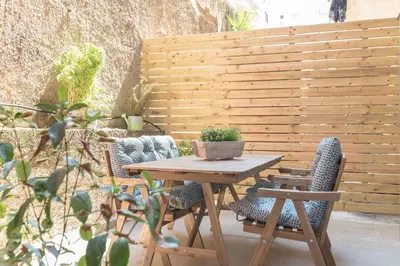 a table and chairs on a patio with a fence at Cozy Flat with Terrace & Patio, next to Lycabettus in Athens