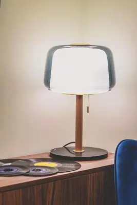 a lamp on top of a desk with a blue chair at Neoclassical Apartment near Acropolis - LivingStone Crystal in Athens