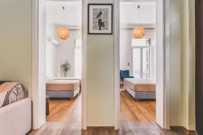 a bedroom with two beds and a hallway with a mirror at Neoclassical Apartment near Acropolis - LivingStone Crystal in Athens