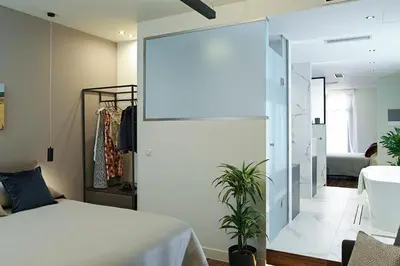a bedroom with a bed and a sliding glass door at The Gem Society Hotel in Athens