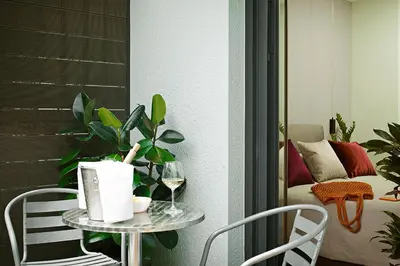 a table with a plant and a glass of wine at The Gem Society Hotel in Athens
