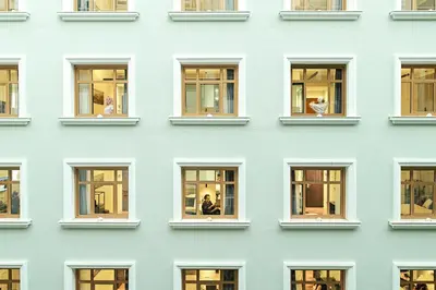 a facade of a blue building with windows at The Gem Society Hotel in Athens