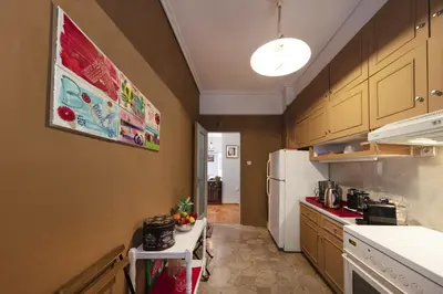 a kitchen with a white refrigerator and a counter at Spacious 3 Bedroom apt near Acropolis museum in Athens