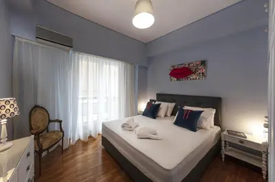 a bedroom with a large bed and a window at Spacious 3 Bedroom apt near Acropolis museum in Athens