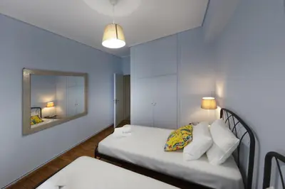 a small room with a bed and a mirror at Spacious 3 Bedroom apt near Acropolis museum in Athens