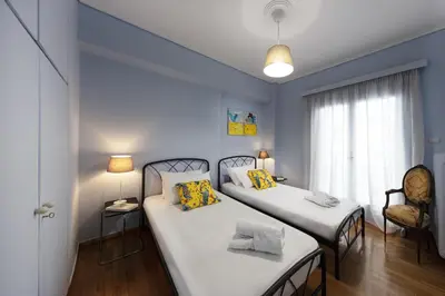 a bedroom with two beds and a window at Spacious 3 Bedroom apt near Acropolis museum in Athens