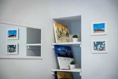 a wall with a mirror and some pictures on it at Beautiful studio at Panathenaic Stadium in Athens