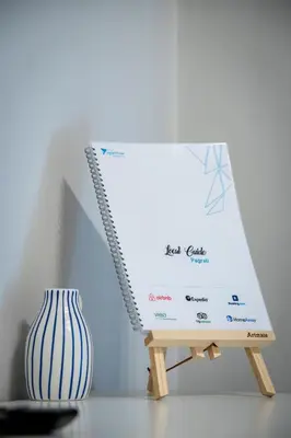 a sign sitting on a stand next to a vase at Beautiful studio at Panathenaic Stadium in Athens