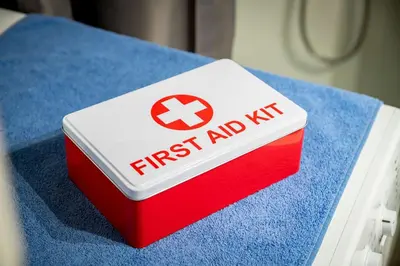 a red and white first aid box sitting on a bed at Beautiful studio at Panathenaic Stadium in Athens
