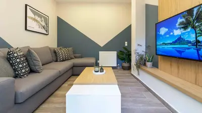 a living room with a couch and a flat screen tv at “Champions” Apartment in N. Kosmos neighbourhood in Athens
