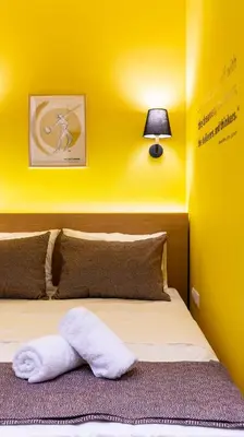 a bedroom with a bed with a white towel on it at “Champions” Apartment in N. Kosmos neighbourhood in Athens