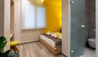 a bedroom with a bed with a window and a toilet at “Champions” Apartment in N. Kosmos neighbourhood in Athens