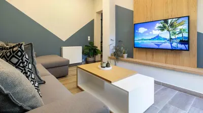 a living room with a tv on a wall at “Champions” Apartment in N. Kosmos neighbourhood in Athens