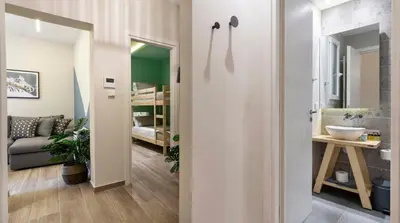a hallway with a room with a bed and a bathroom at “Champions” Apartment in N. Kosmos neighbourhood in Athens