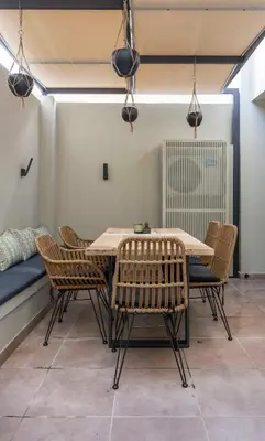 a table and chairs in a room with a bed at “Champions” Apartment in N. Kosmos neighbourhood in Athens