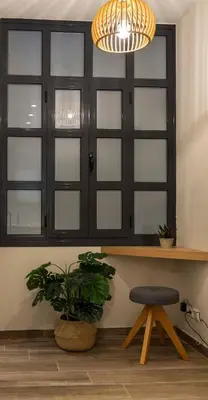 a black cabinet with glass doors and a stool at “Champions” Apartment in N. Kosmos neighbourhood in Athens
