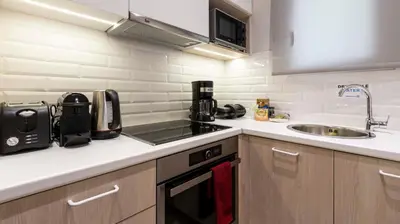 a small kitchen with a sink and a stove at “Champions” Apartment in N. Kosmos neighbourhood in Athens