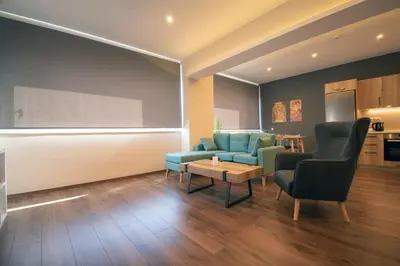 a living room with a couch and two chairs and a table at Abstract Flat With Urban View in Athens