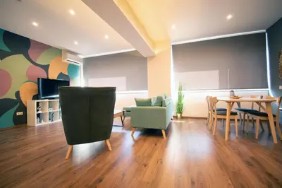 a living room with a table and chairs at Abstract Flat With Urban View in Athens