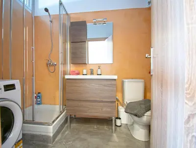 a bathroom with a sink and a toilet and a shower at Abstract Flat With Urban View in Athens