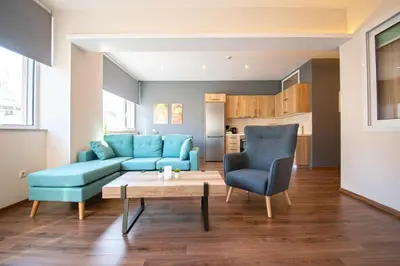 a living room with a couch and a table and chairs at Abstract Flat With Urban View in Athens