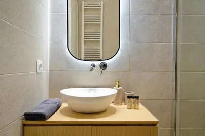 a bathroom with a bowl sink and a mirror at The Flirty Athens apartment in Athens