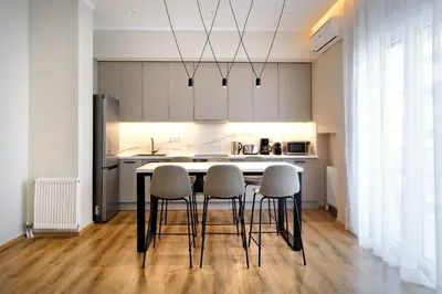 a kitchen with a table and chairs in a room at The Flirty Athens apartment in Athens